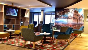 a living room filled with furniture and a table at Holiday Inn Glasgow - East Kilbride, an IHG Hotel in East Kilbride
