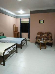 a living room with two beds and a couch at Mulu Diana Homestay in Mulu