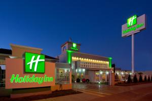 a hospital with green neon signs on a building at Holiday Inn Durango by IHG in Durango