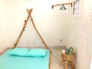 a bed in a corner of a room at "NOMORE" Gallery and Guesthouse in Yogyakarta