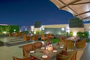 an outdoor restaurant with tables and chairs at night at Regenta Central Cassia Zirakpur Chandigarh in Chandīgarh