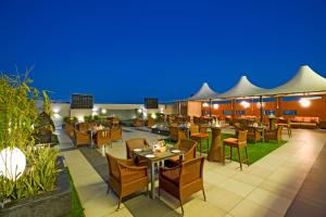 a restaurant with tables and chairs at night at Regenta Central Cassia Zirakpur Chandigarh in Chandīgarh