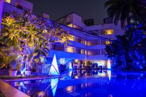 a hotel with a swimming pool at night at The Park Baga River Goa in Baga +211 photos