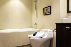 e bagno con servizi igienici bianchi e vasca. di Stunning 3BR Apartment at The Branz BSD City By Travelio a Samporo Altre 18 foto