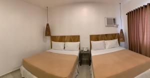 Rúm í herbergi á Cebu R Resort Tabuelan