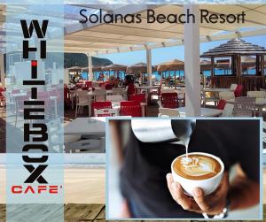 a picture of a person holding a cup of coffee at Sardinia Yellow House in Solanas
