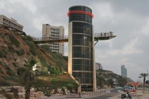 a building on the side of a street with a bridge at King Koresh Hotel in Netanya