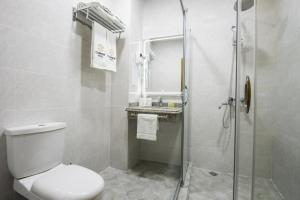 a bathroom with a toilet and a glass shower at Corner Hotel Tashkent in Tashkent +23 photos