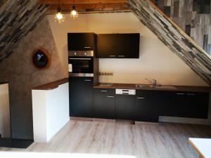 a kitchen with black cabinets and a sink at Haus der Harmonie in Hameln