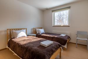 Llit o llits en una habitació de Iguru Ski Chalet