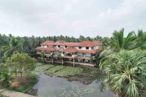 an aerial view of a resort with palm trees at Sterling Palavelli Godavari in Rāzole