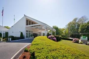 a white building with a sign in front of it at Hotel Cape Cod in Falmouth