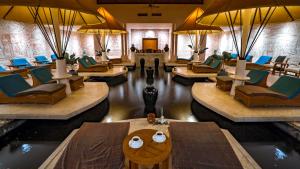 a hotel lobby with tables and chairs and a lobby at Nexus Resort & Spa Karambunai in Kota Kinabalu