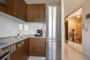 a kitchen with a stainless steel refrigerator at Melon Suites in Thessaloniki