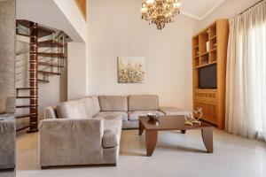 a living room with a couch and a table at Melon Suites in Thessaloniki