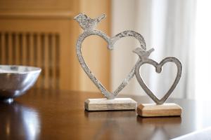 two metal hearts sitting on top of a table at Melon Suites in Thessaloniki