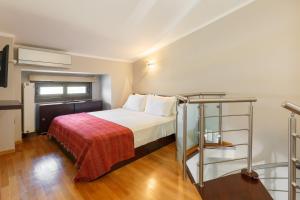 a hotel room with a bed with a red blanket at Melon Suites in Thessaloniki