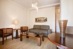 a living room with a couch and a table at Melon Suites in Thessaloniki