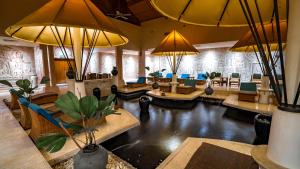 a living room with a pond in the middle at Nexus Resort & Spa Karambunai in Kota Kinabalu