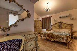 an ornate bedroom with a bed and a mirror at Dalya Life in Göcek
