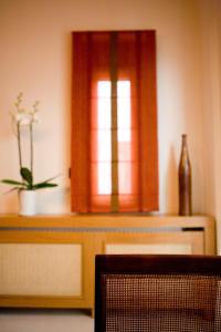 a window with a potted plant on top of a table at Melon Suites in Thessaloniki