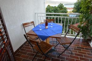 a table with two chairs and a blue table cloth on a balcony at Maja in Kornić