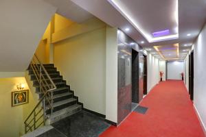 a hallway with stairs and a red carpet at Hotel Windsor Castle Inn Brigade Rd in Bangalore