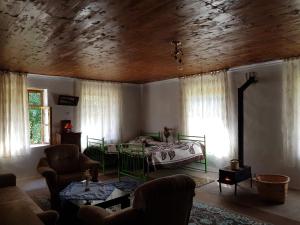 a living room with a bed and a couch at Rustic Inn "Koba's Sakhli" in Mestia
