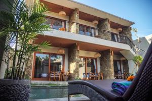 a house with a swimming pool in front of it at Bisma Terrace Suite Ubud in Ubud