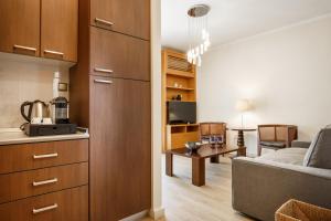 a kitchen and living room with a couch and a table at Melon Suites in Thessaloniki
