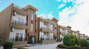 a row of apartment buildings with balconies on them at Vrinda Anandam Resort in Vrindāvan