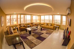 a large living room with couches and a table at Swiss Spirit Hotel & Suites Taif in Taif