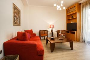 a living room with a red couch and a coffee table at Melon Suites in Thessaloniki