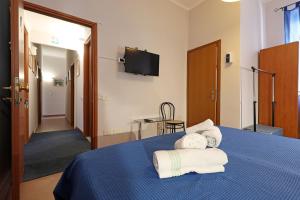 a hotel room with a blue bed with towels on it at casa ros via ostiense 73 in Rome