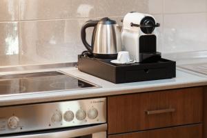 a kitchen with a coffee maker on a counter at Melon Suites in Thessaloniki