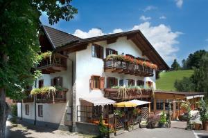 un edificio con macetas en los balcones en Gasthof zum Schlern, en Fiè