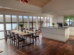 a kitchen and dining room with a table and chairs at Thor´s Guest house in Ryggur