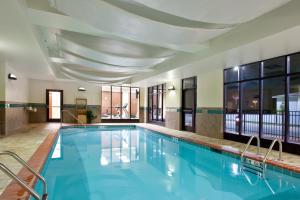 a large swimming pool with blue water in a building at Holiday Inn Saint Louis-Fairview Heights by IHG in Fairview Heights