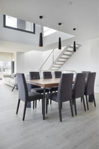 a dining room with a table and chairs and a staircase at Villa Alimar - Basque Stay in San Sebastián