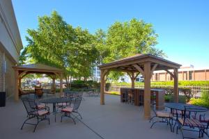 a patio with tables and chairs and gazebos at Holiday Inn Sioux Falls-City Center by IHG in Sioux Falls