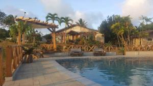 a house with a swimming pool in front of a house at Spacio Caliraya Bed & Breakfast in Lumban