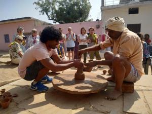 two men playing a game of chess in front of a crowd at Homes of India in Orchha