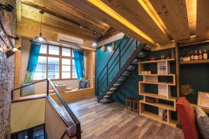 a staircase in a room with wooden ceilings and a window at Small Bridge Good Home in Tainan