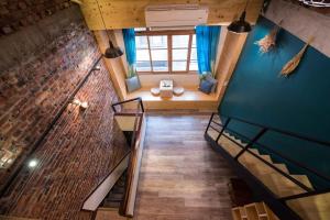 an overhead view of a room with a staircase and a brick wall at Small Bridge Good Home in Tainan