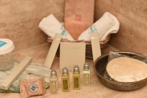 a group of four bottles of oil next to a bowl of bread at Hotel Unique-Boutique Class - Adults Only in Fethiye