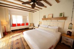 a bedroom with a large white bed with a ceiling at Hotel Unique-Boutique Class - Adults Only in Fethiye