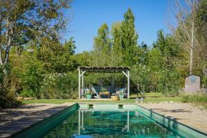 a swimming pool in a yard with a pergola at Beautiful country house near Ronda in Arriate