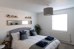 a bedroom with a bed with blue towels on it at No 88 UPPER ST GILES - Elegant, Stylish Townhouse in Norwich