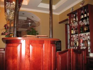 a bar with wooden cabinets and bottles of alcohol at Готель Преміум in Lviv