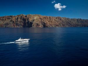 a boat in the middle of a large body of water at Reid's Palace, A Belmond Hotel, Madeira in Funchal